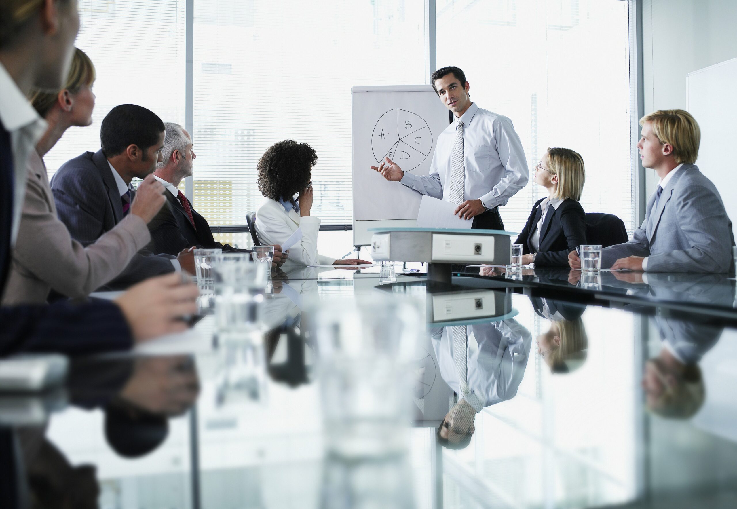 Group of office workers in a boardroom presentation